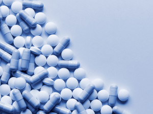 Pharmaceutical pills scattered on table background with copyspace.